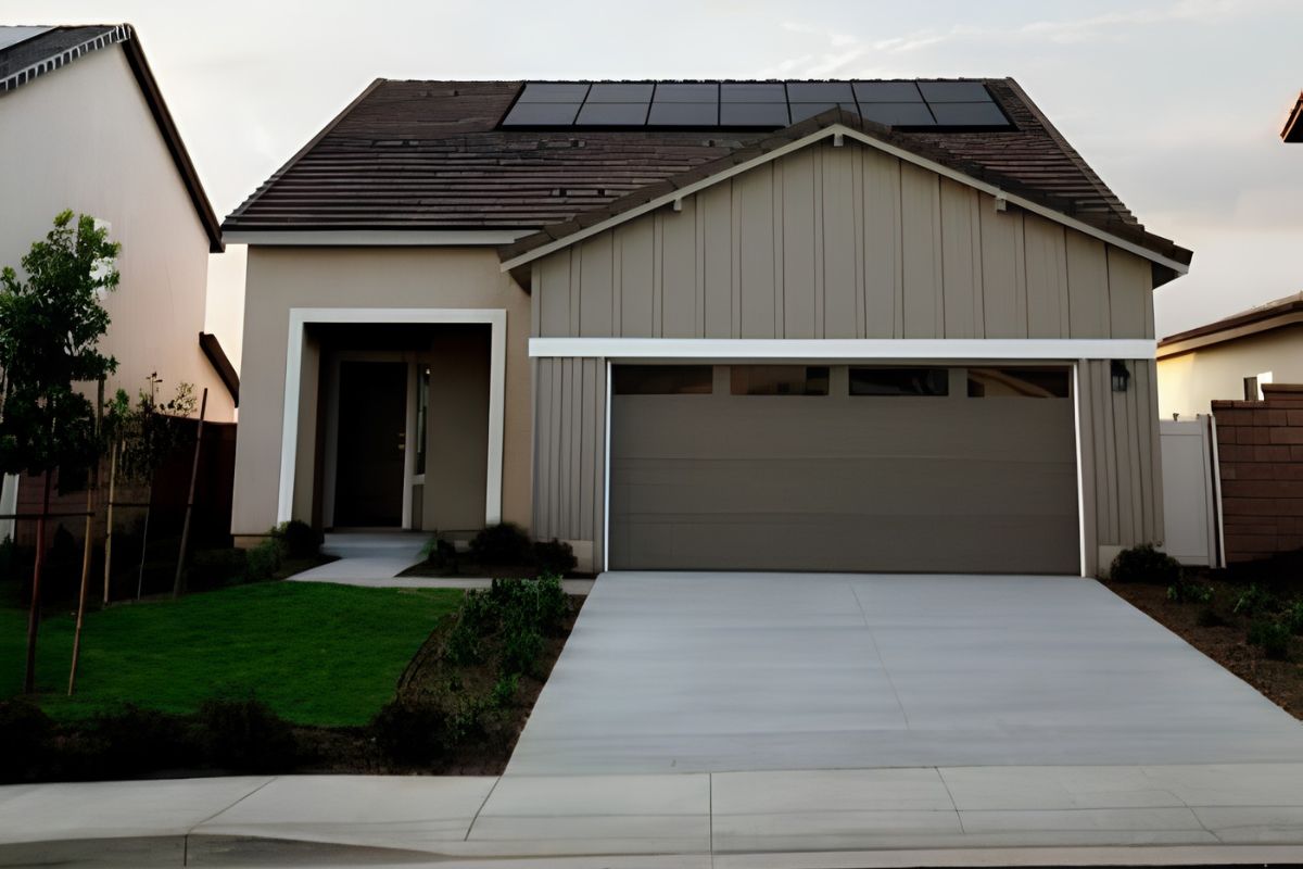 Modern home with a sectional garage door featuring horizontal panels and a row of small windows at the top.