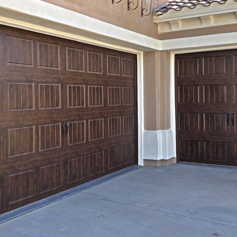 Stylish wooden garage doors with elegant design, enhancing curb appeal of modern home exterior.