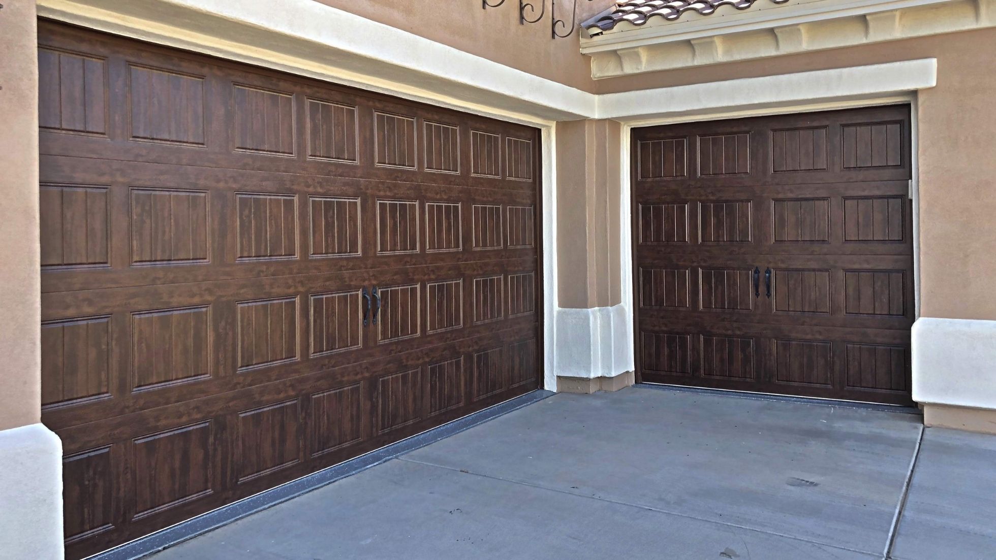 Stylish wooden garage doors with elegant design, enhancing curb appeal of modern home exterior.